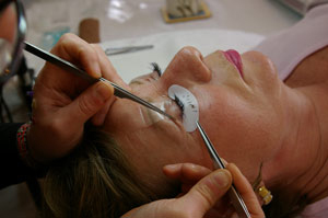 Patty having eyelashes applied