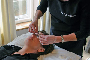 Gently taping the eyes for even application